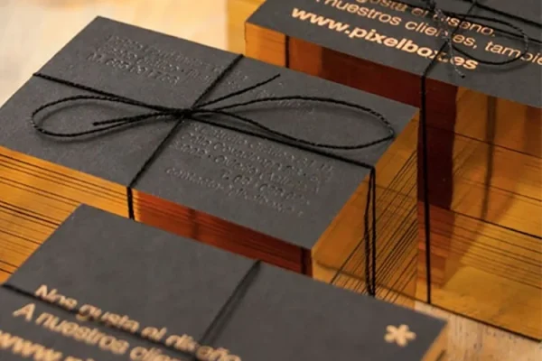 Business Cards — luxury business cards #1078 Luxury business cards with gold edges and embossed text, tied with black string.