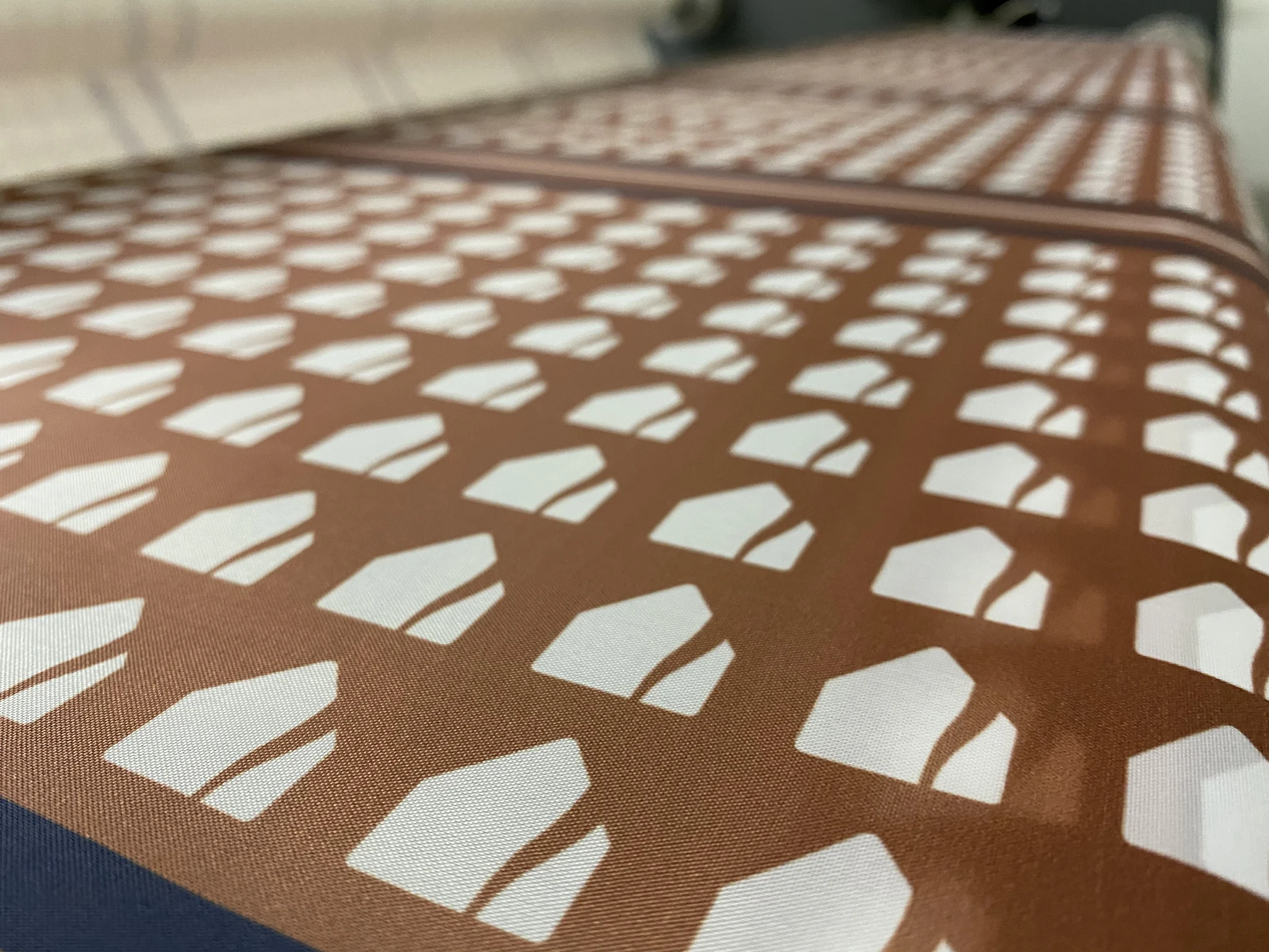 Patterned fabric with geometric shapes, suitable for textile applications.