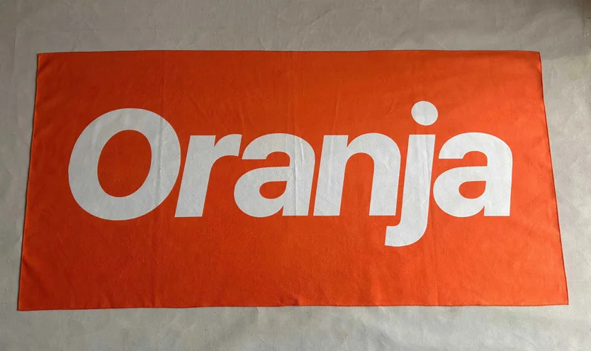 Custom towel with 'Oranja' text, showcasing custom towel printing service.