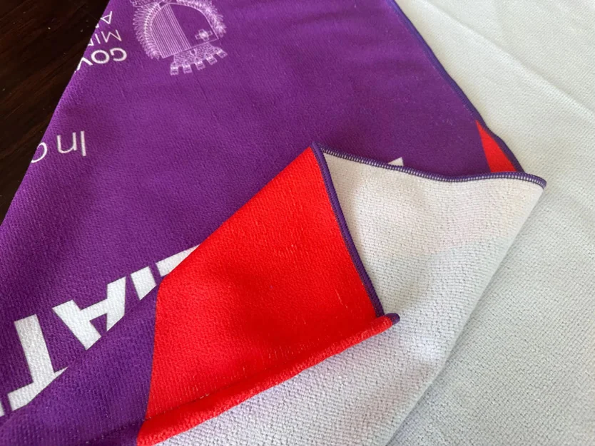 Custom towel with vibrant design for promotional use.