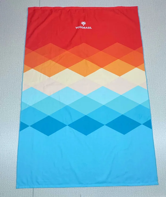 Custom towel with geometric pattern and Yggdrasil logo for promotional use.