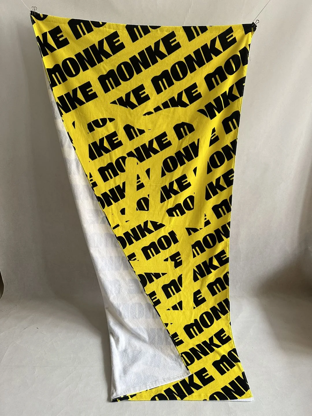 Custom towel with bold text design for promotional use.