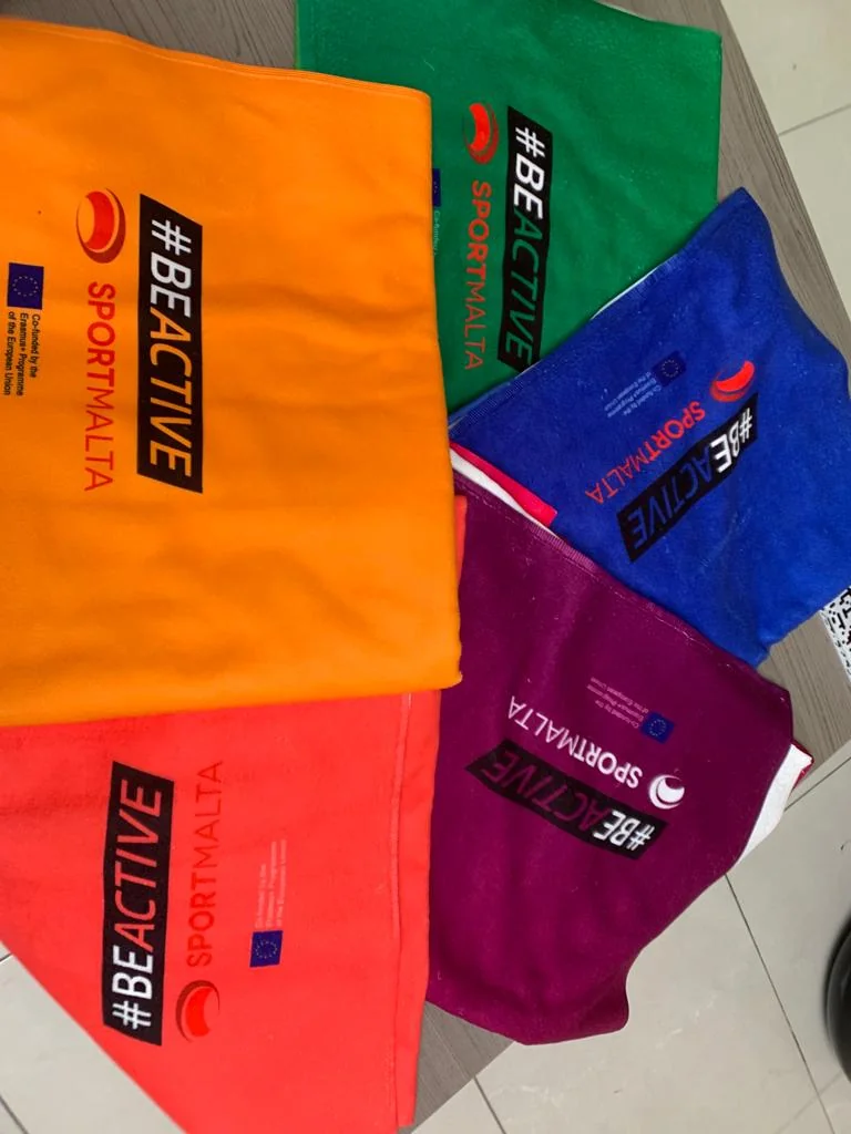 Custom towels with SportMalta and BeActive branding, showcasing custom towel printing.