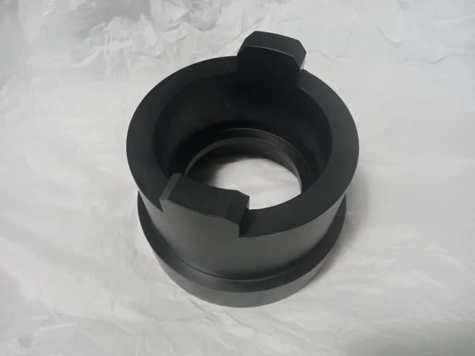 Black metal component with circular design, possibly for industrial use.