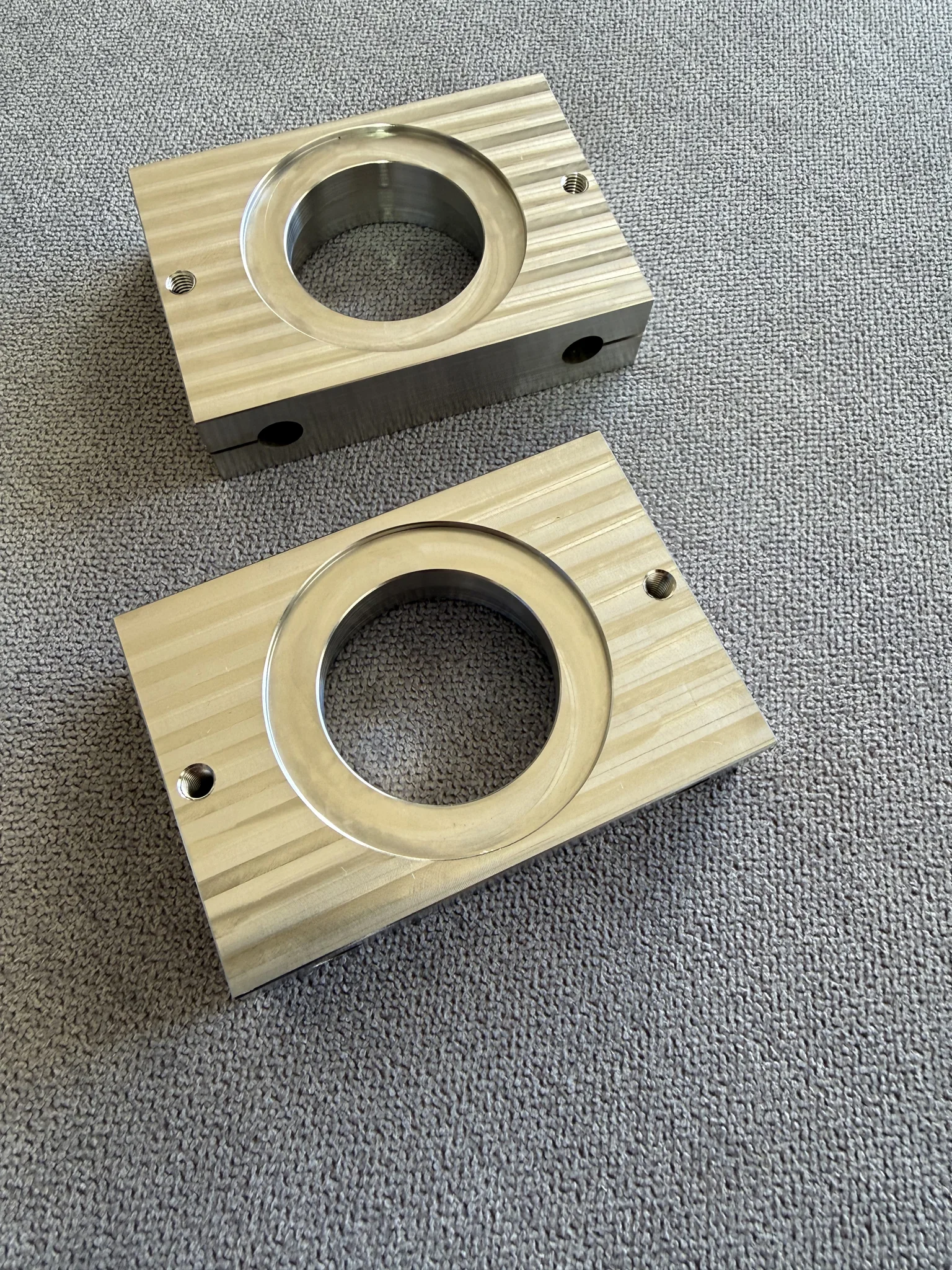 Engraved metal blocks with circular cutouts for laser engraving service.