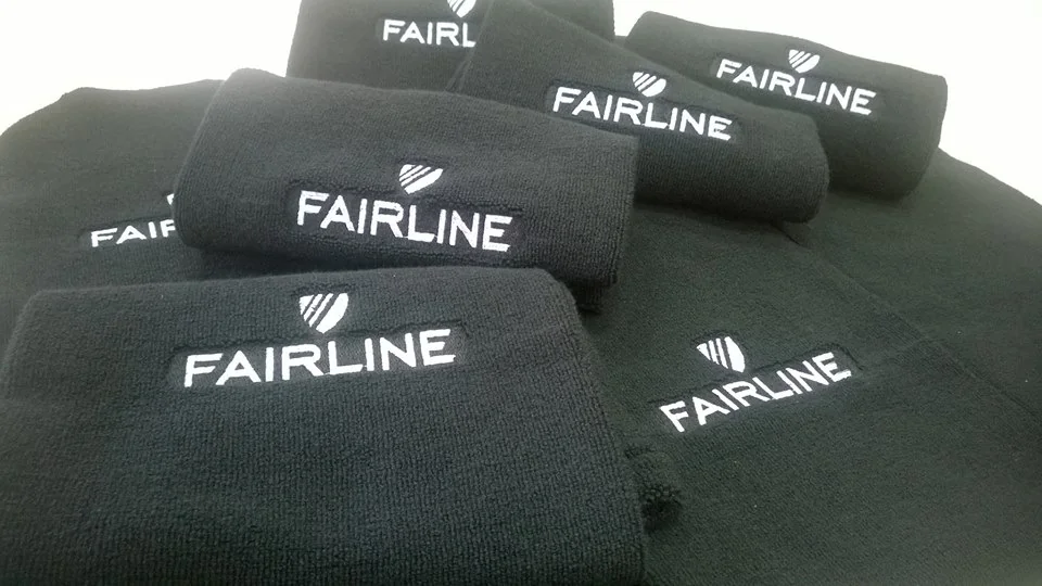 Embroidered beanies with Fairline logo showcasing embroidery service.