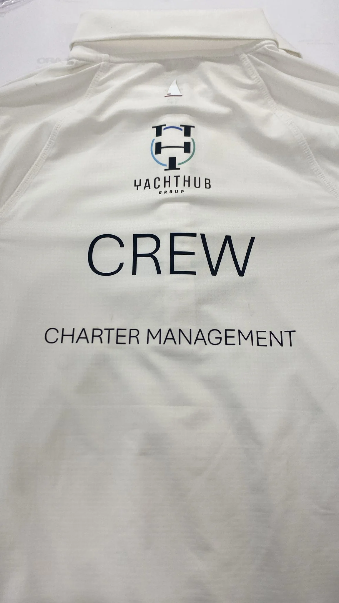 Embroidered polo shirt with Yachthub Group logo and crew text.
