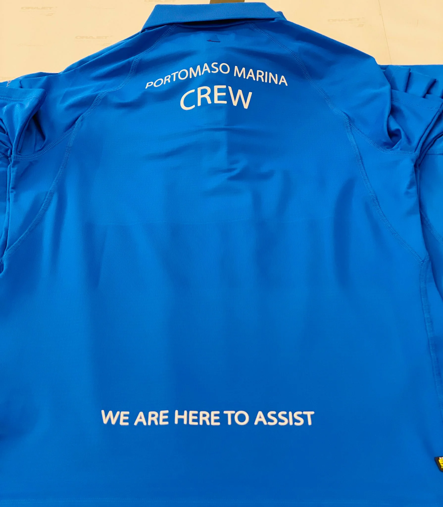 Blue embroidered polo shirt for Portomaso Marina Crew, showcasing workwear embroidery.