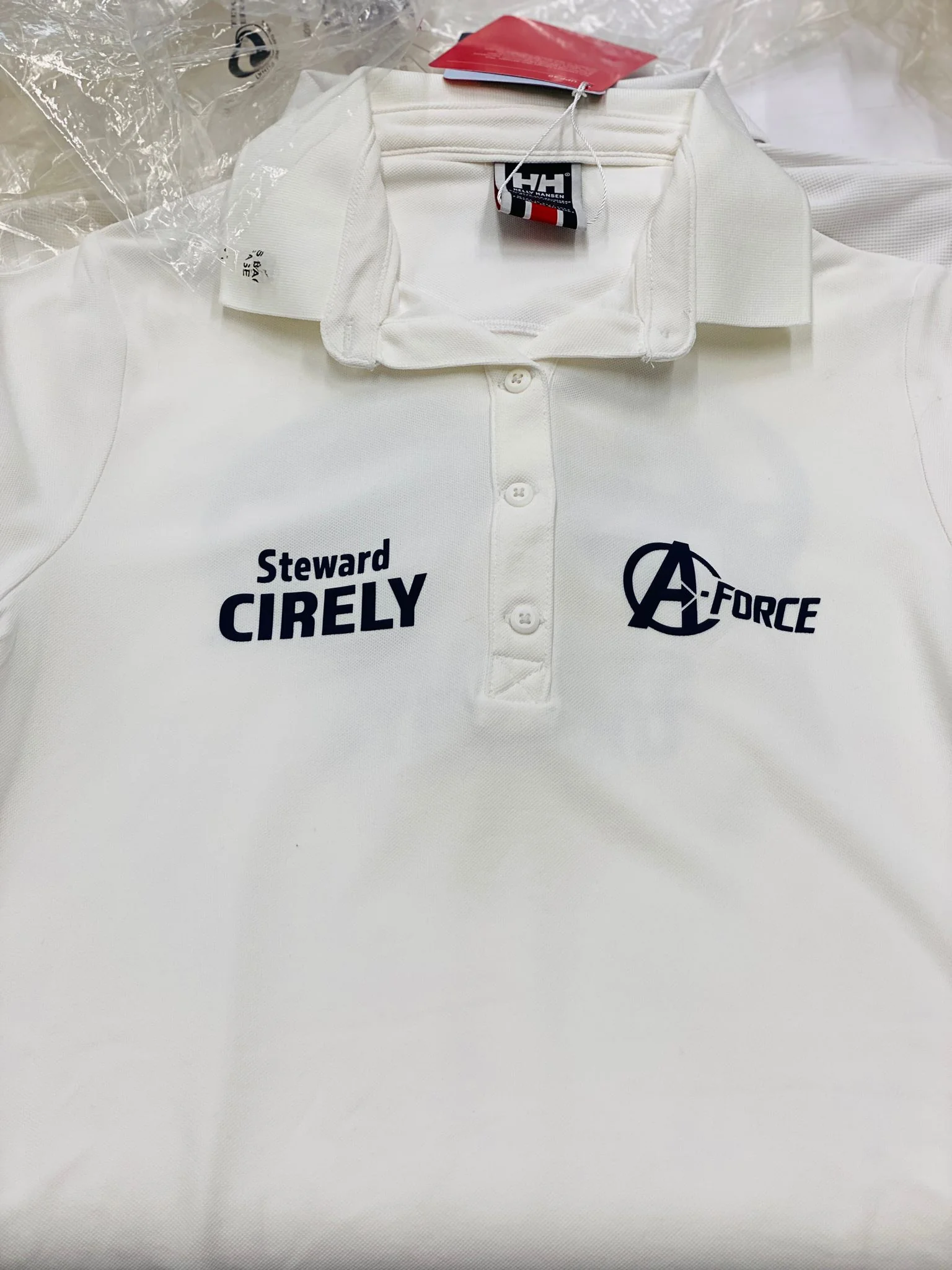 White polo shirt with embroidered logos for workwear embroidery.