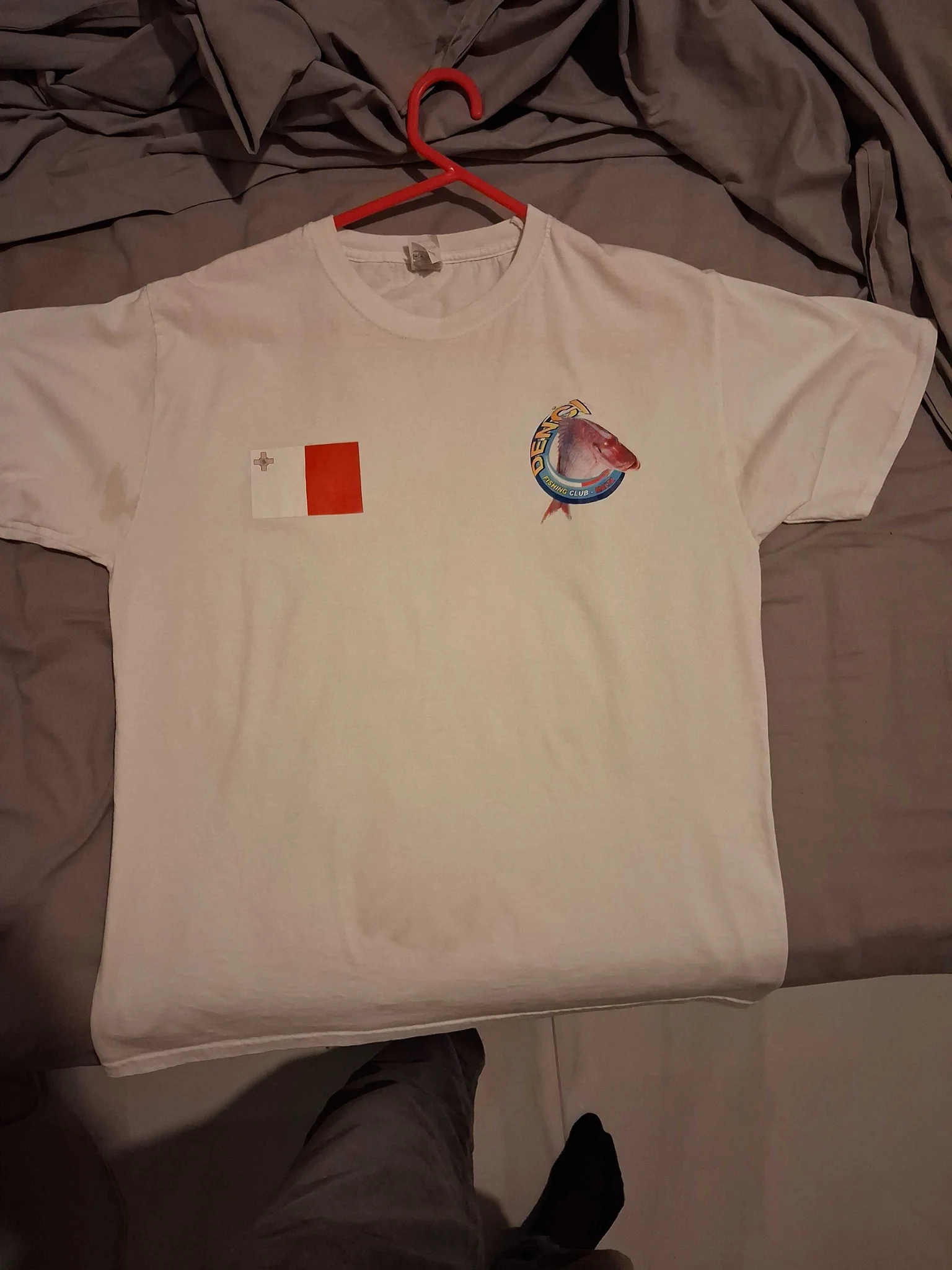White t-shirt with Maltese flag and fish emblem, showcasing t-shirt printing.