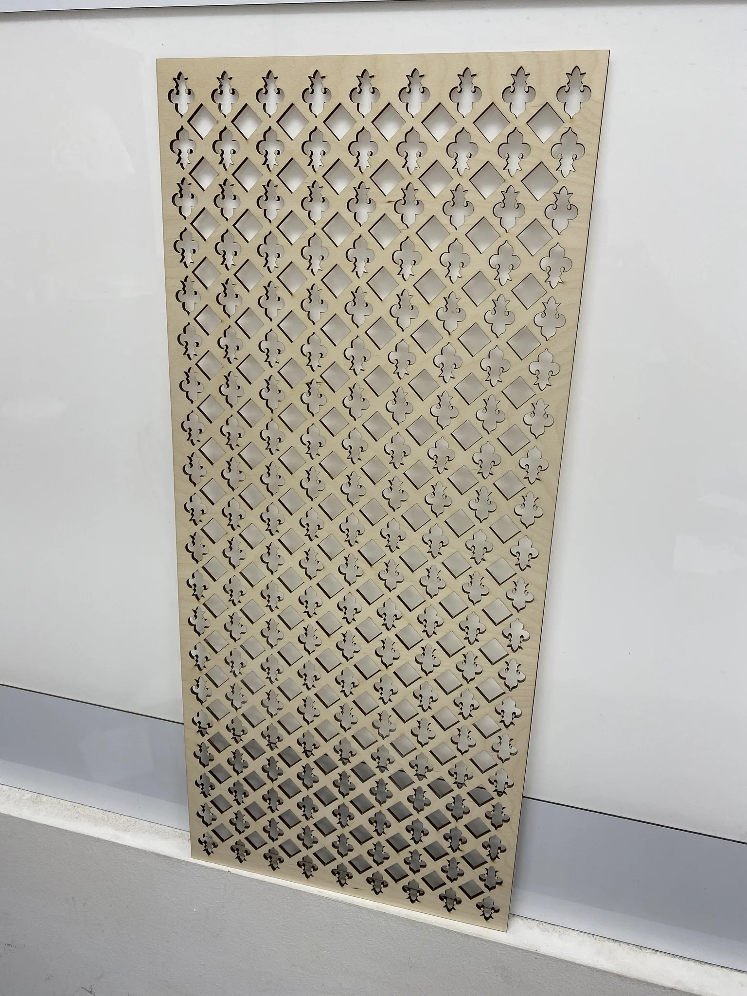 Laser-cut decorative panel showcasing intricate design for engraving service.
