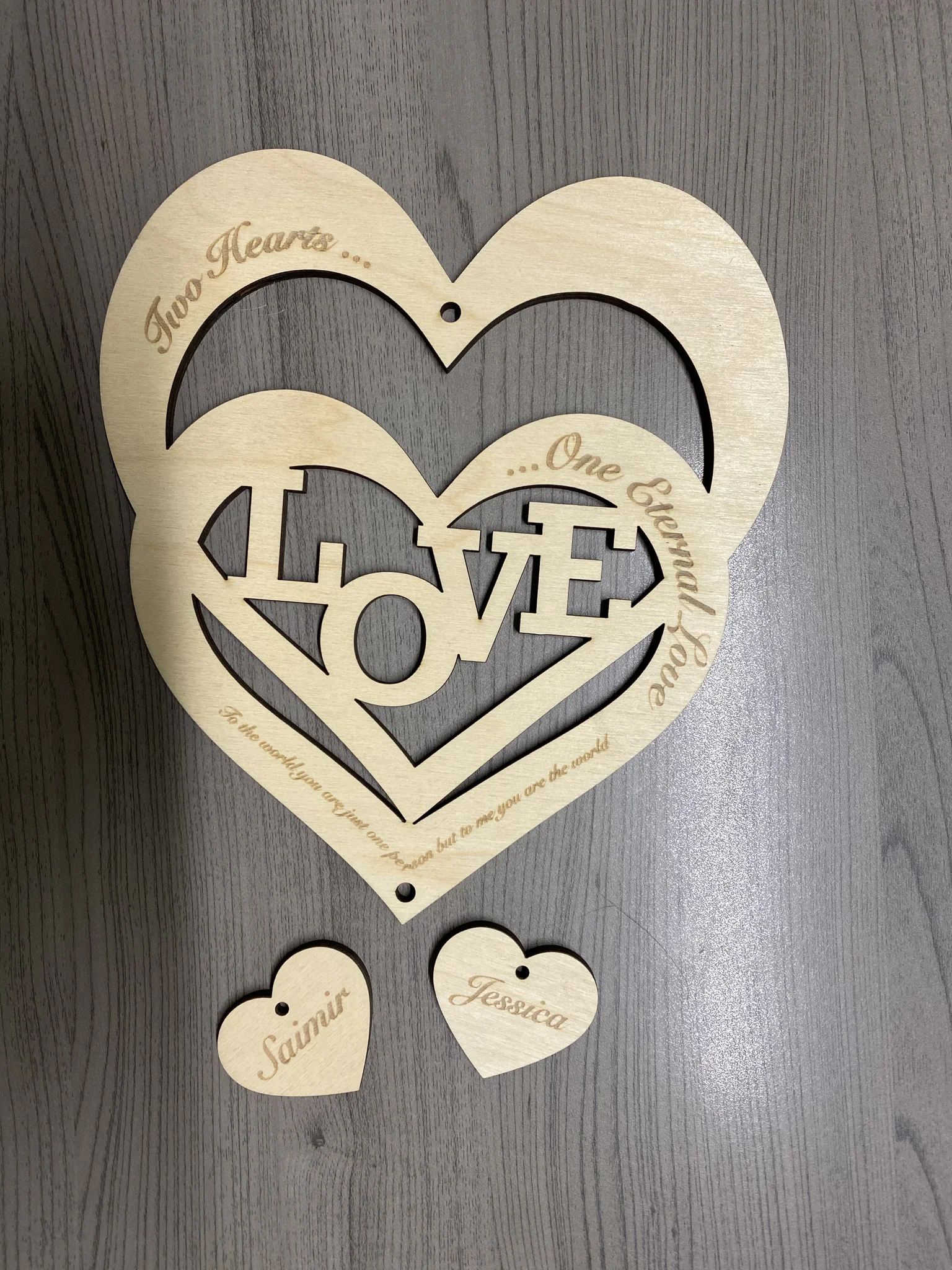 Laser cut wooden love hearts with engraving, ideal for weddings.