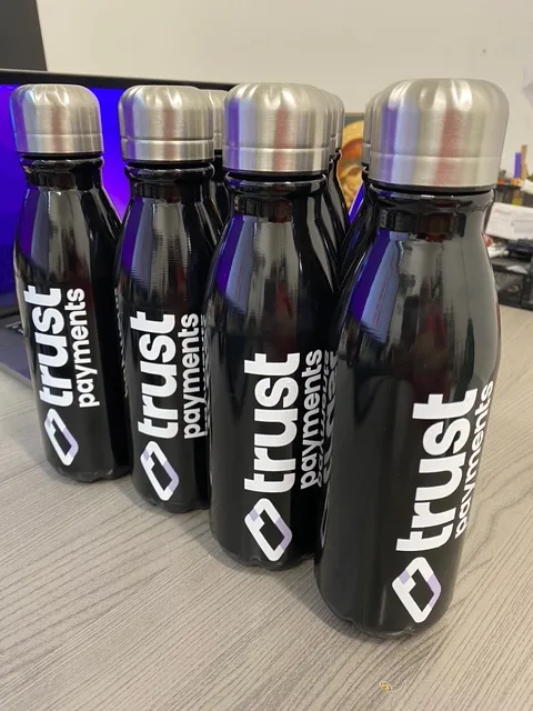Black insulated steel bottles printed with Trust Payments logo.