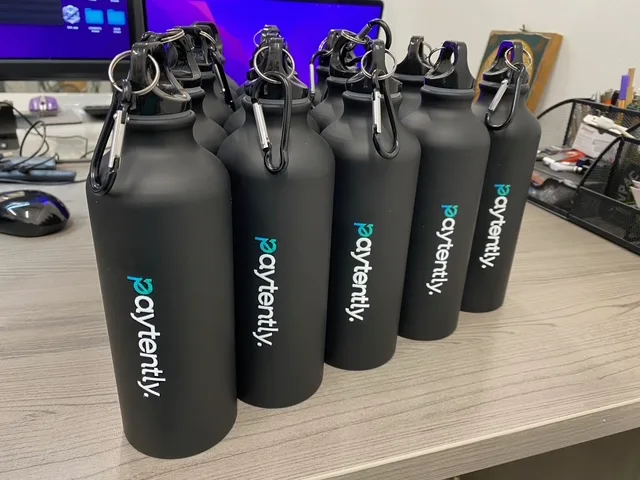 Black aluminium sports bottles with carabiners branded for Paytently.