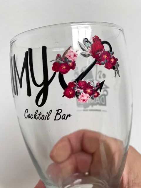 Wine glass printed with AMY Cocktail Bar floral logo, custom glass printing in Malta.