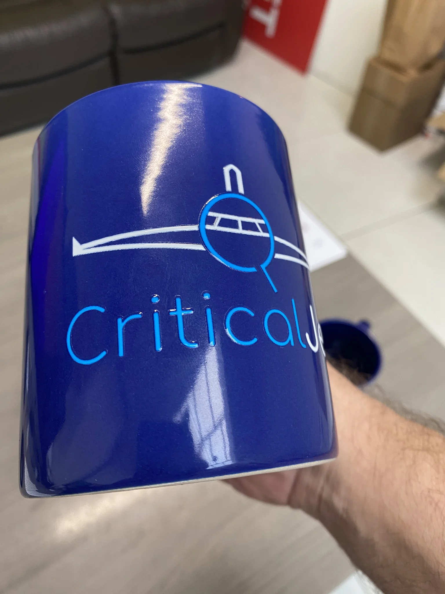 Blue ceramic mug with printed CriticalJet logo, custom mug printing in Malta.